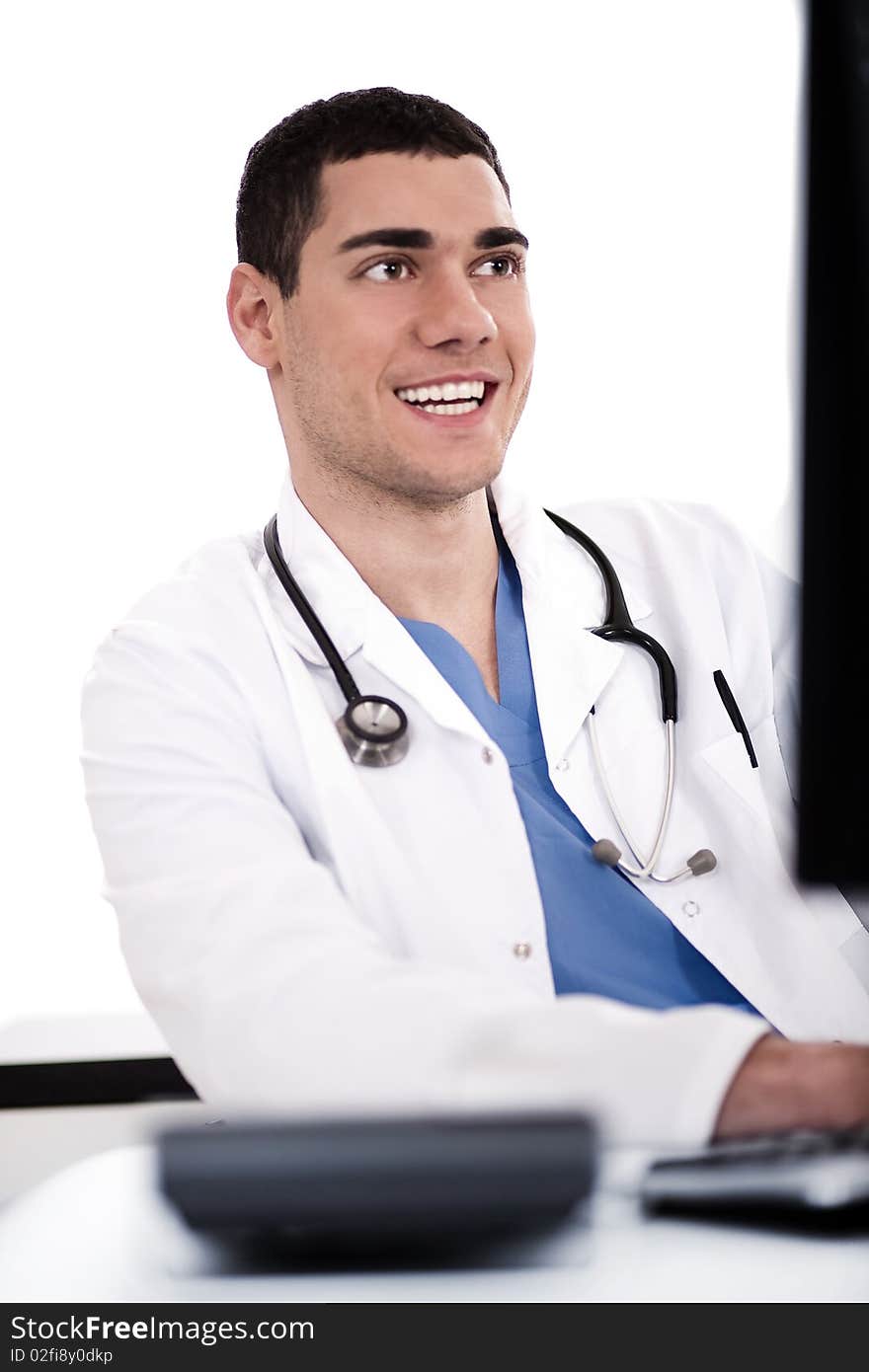 Smiling young doctor at his office over white background