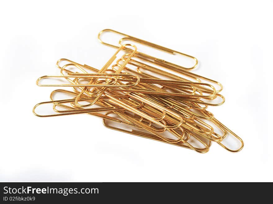 Gold paper clips on a white background