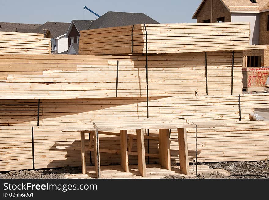 Roof trusses piled outside construction site