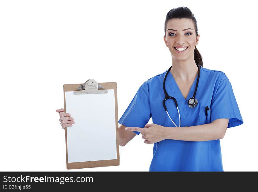 Portrait of young nurse pointing blank clipboard over isolated white background