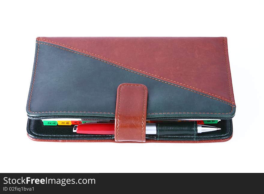 Leather office organizer on blue with a red pen. Leather office organizer on blue with a red pen