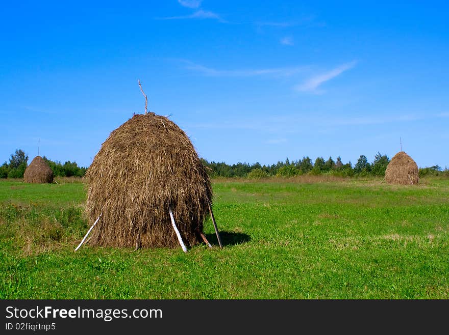 Rural view with three haystacks