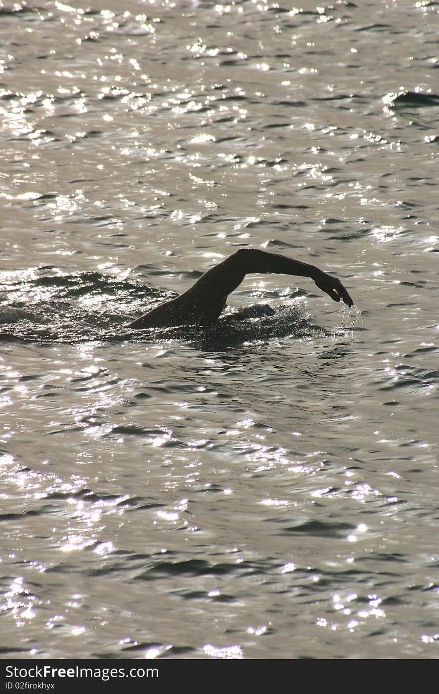 Single night swimmer in the ocean