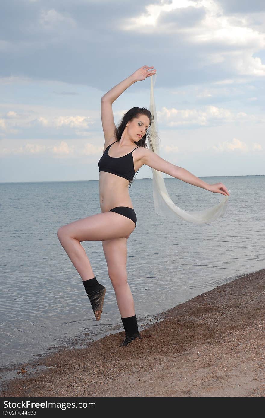 Girl dances on a beach