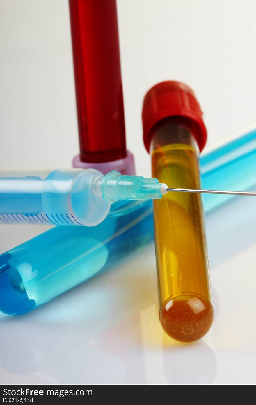 Glass test tubes filled with liquid for an experiment in a science research lab. Search and testing of serum against the virus Covid-19