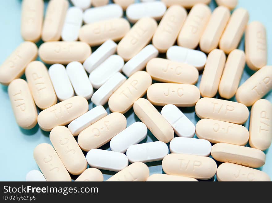 Capsules and pills on a blue background