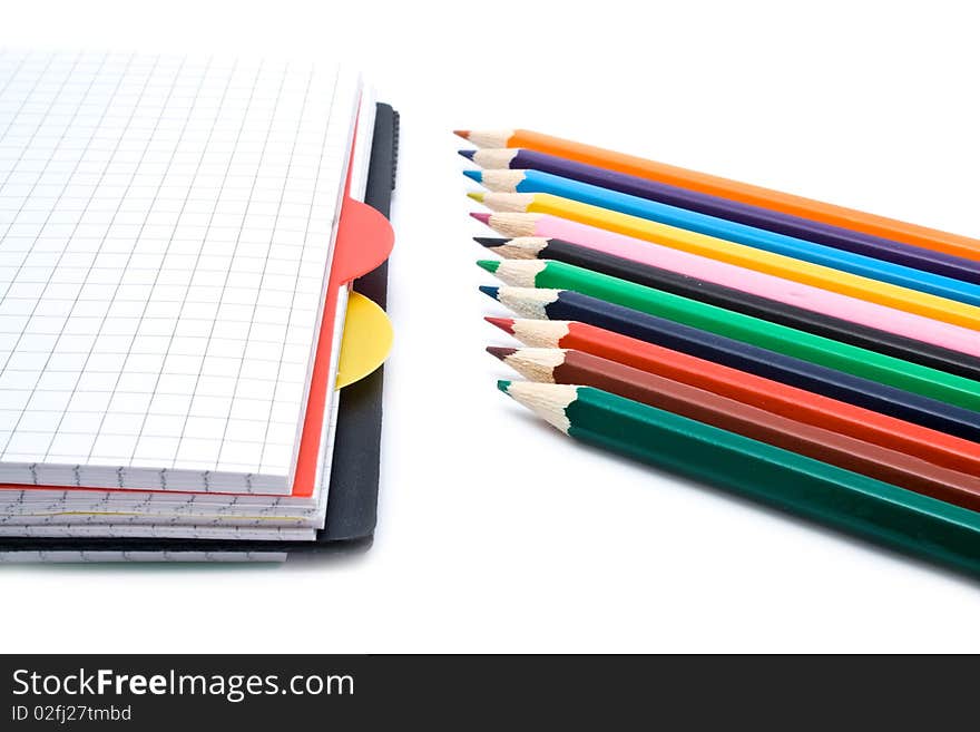 Notebook with a spring and pencils on a white background