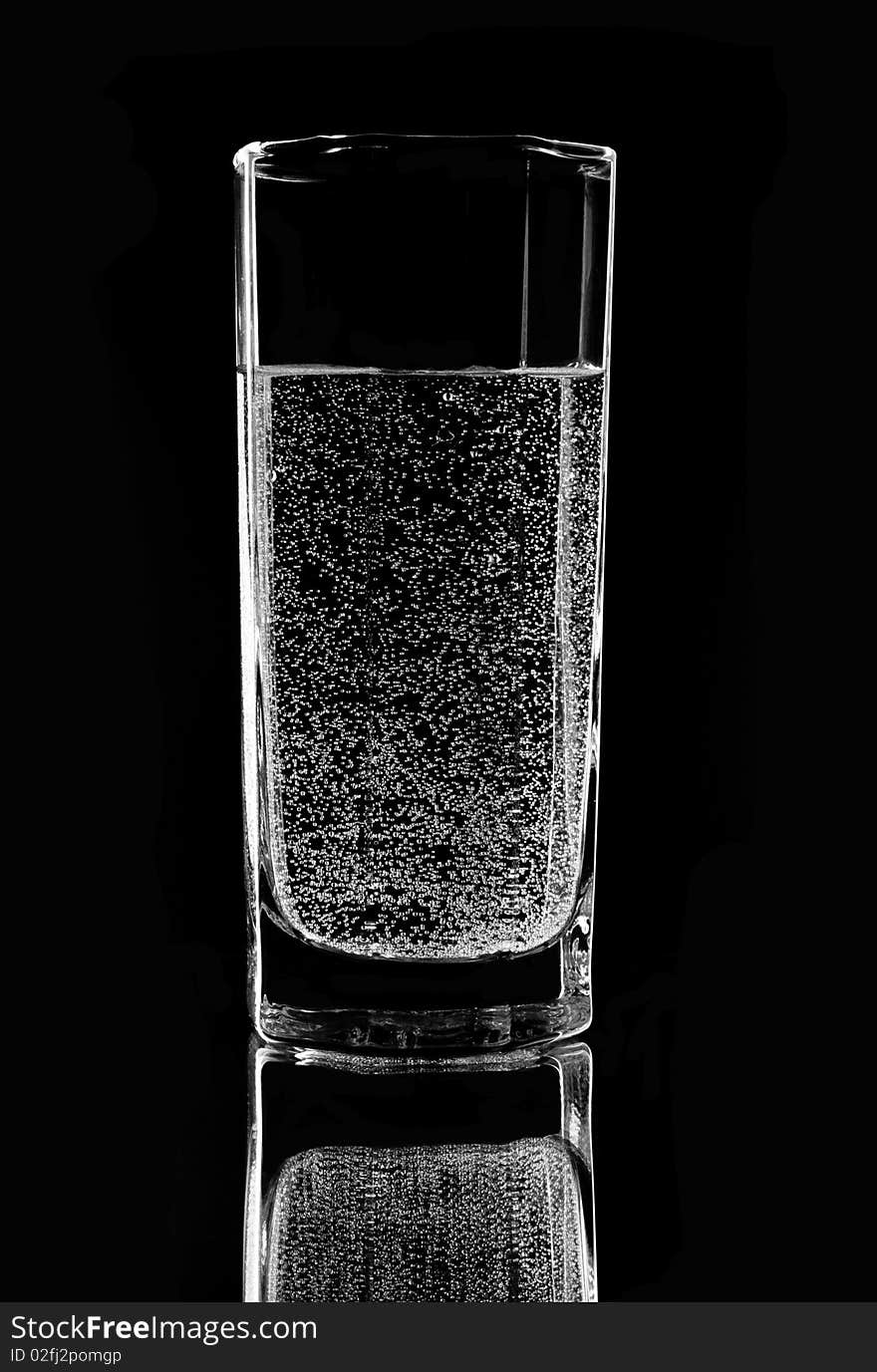 Glass with water on a black background