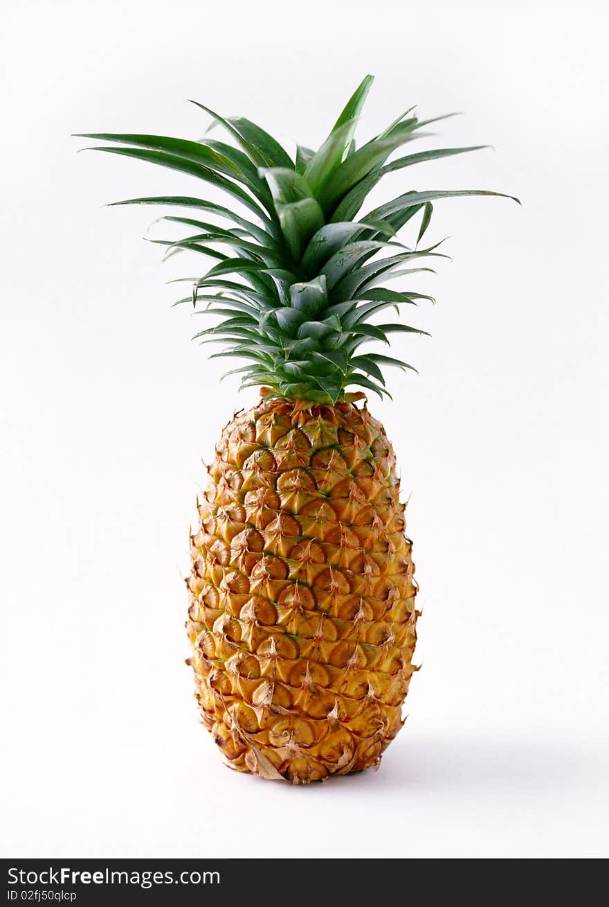 A ripe pineapple on a white background