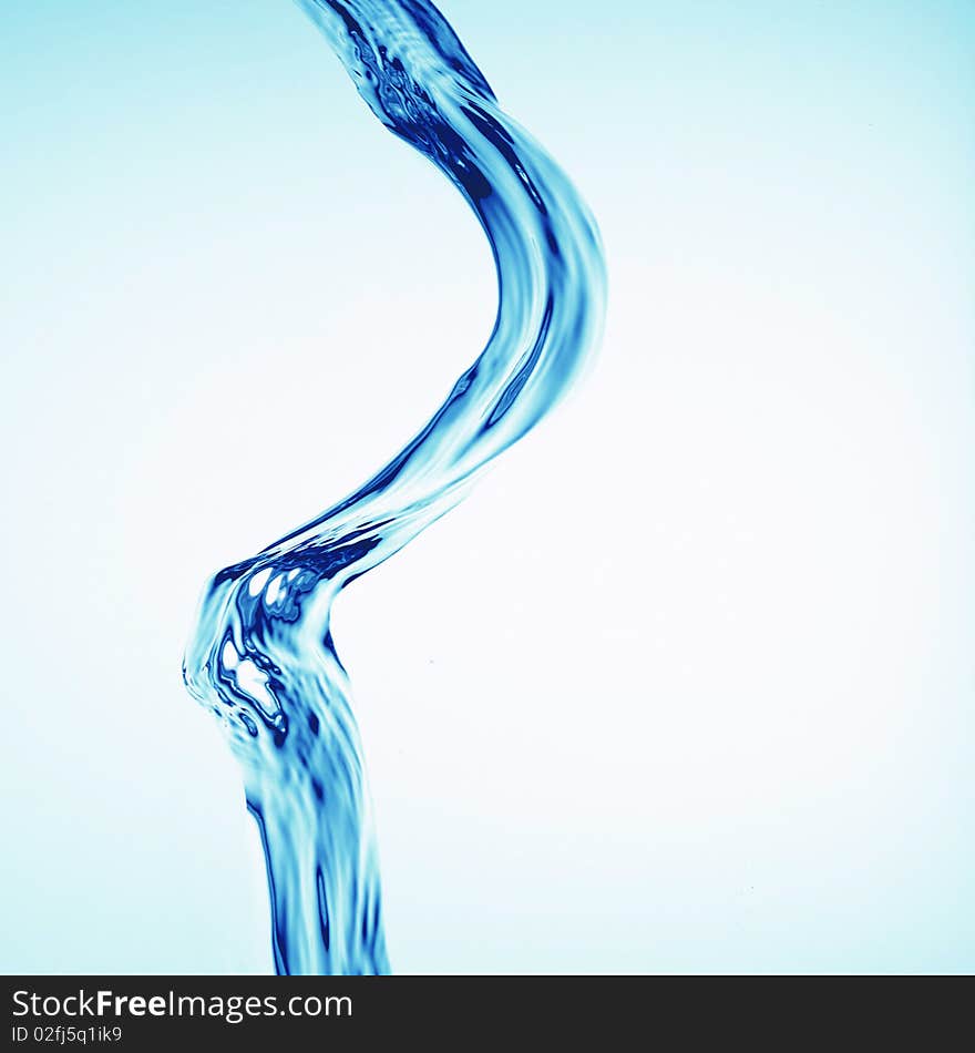 Flowing stream of water on a light background. Flowing stream of water on a light background