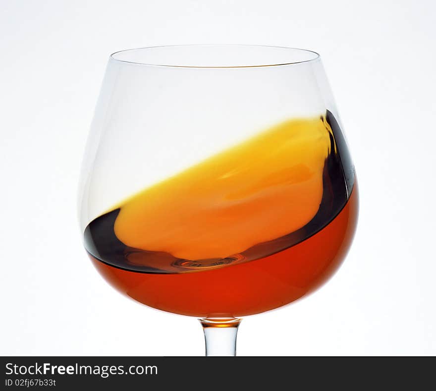 A glass of brandy on a white background