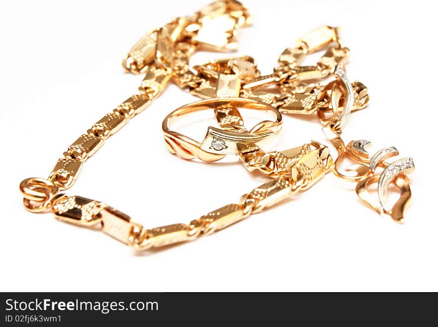 The isolated photo of golden chain, ring and a pendant. The isolated photo of golden chain, ring and a pendant