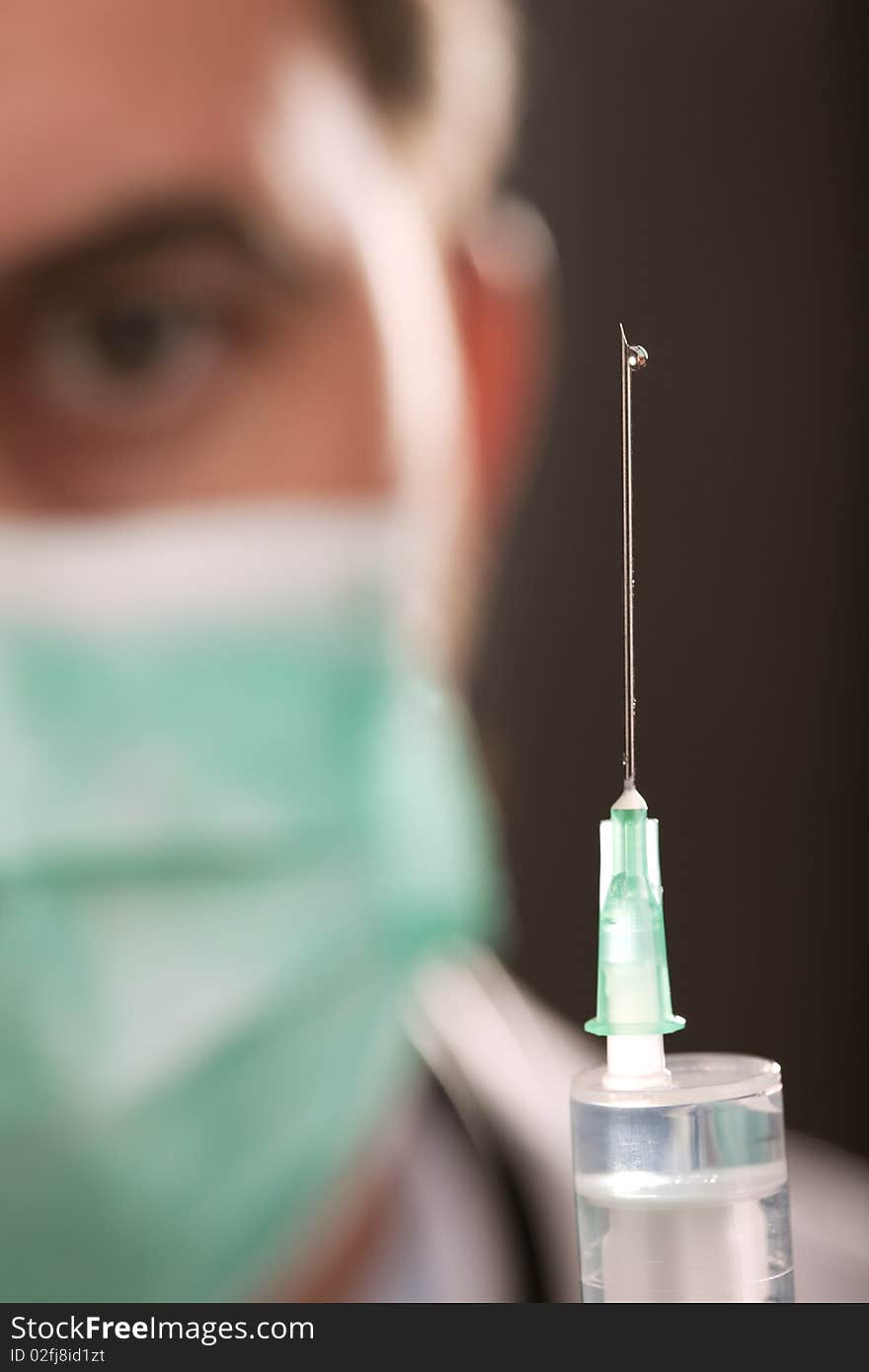 Doctor With Medical Syringe In Hands