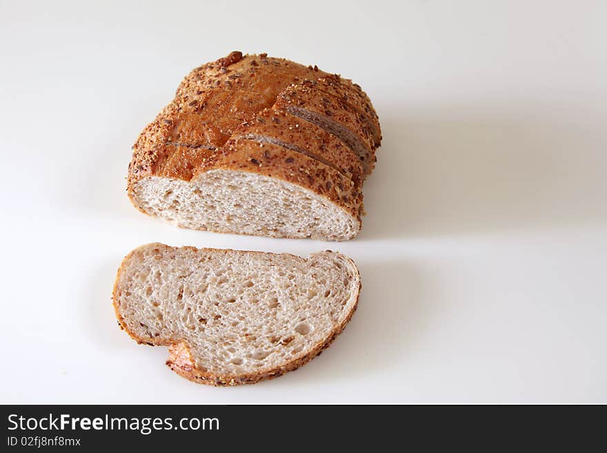 Fresh Baked Bread On Witer Background, one sliced