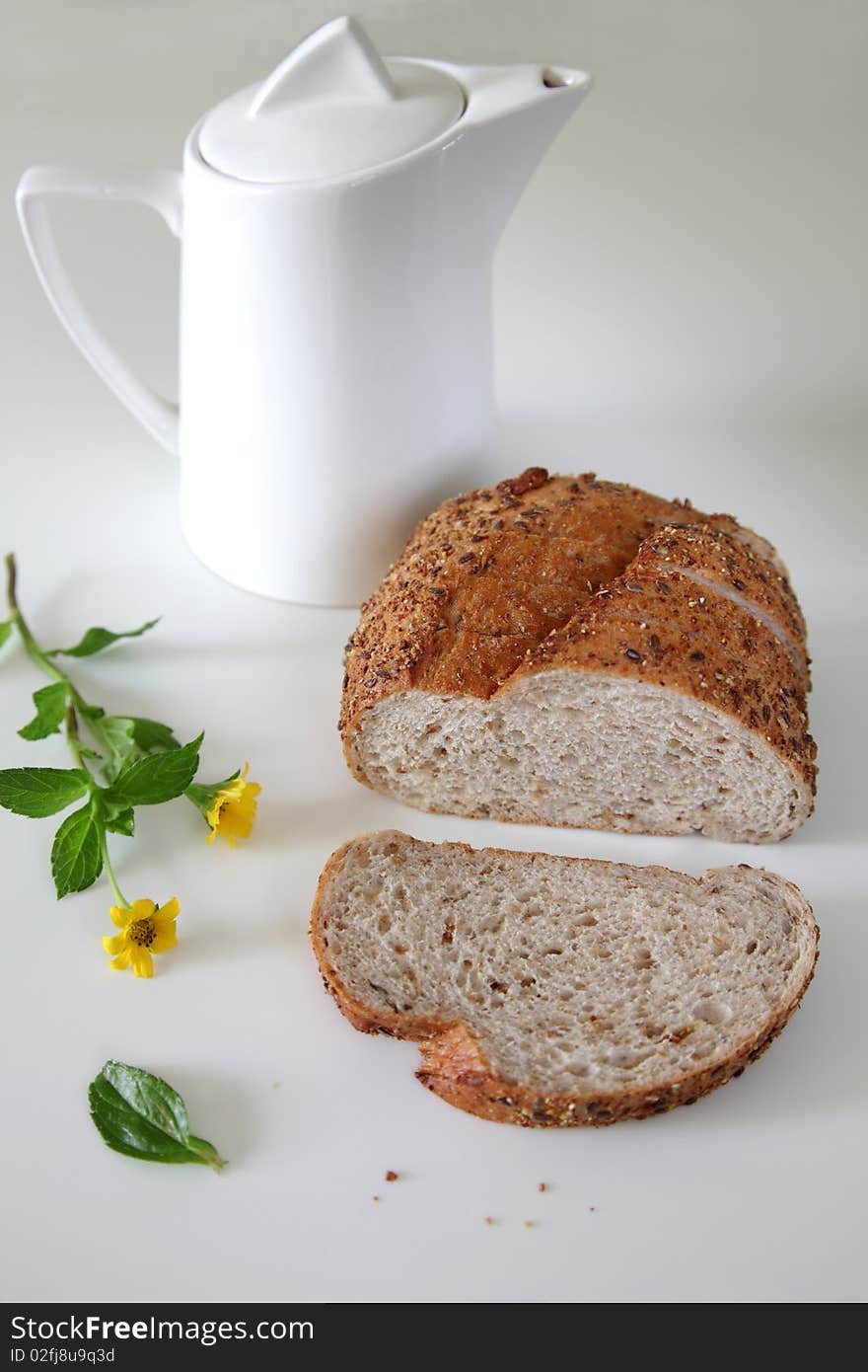 Fresh Baked Bread On Witer Background, one sliced