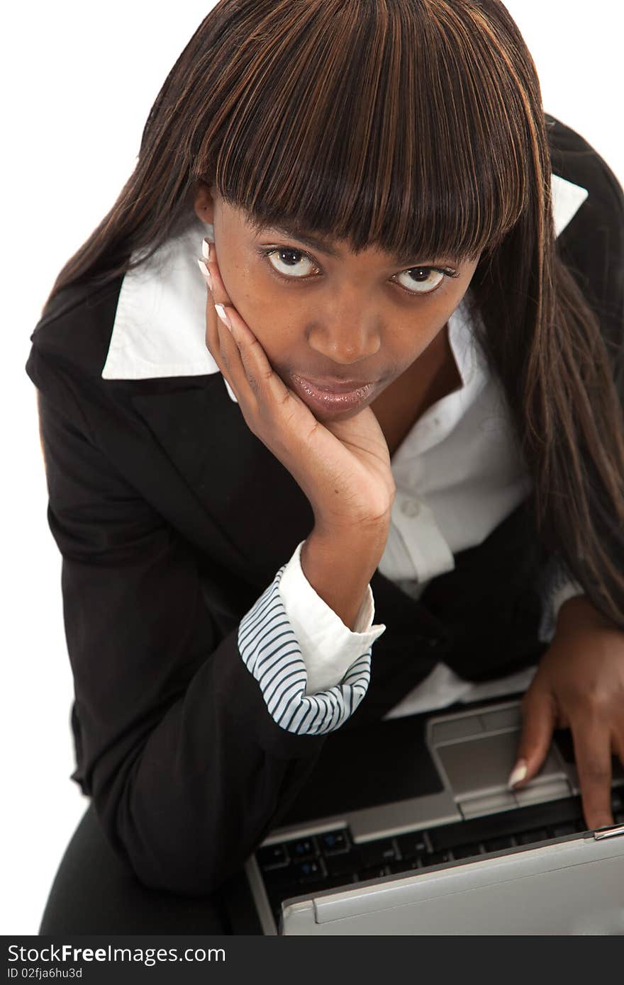 Young black female lawyer with face in hand on laptop looking up