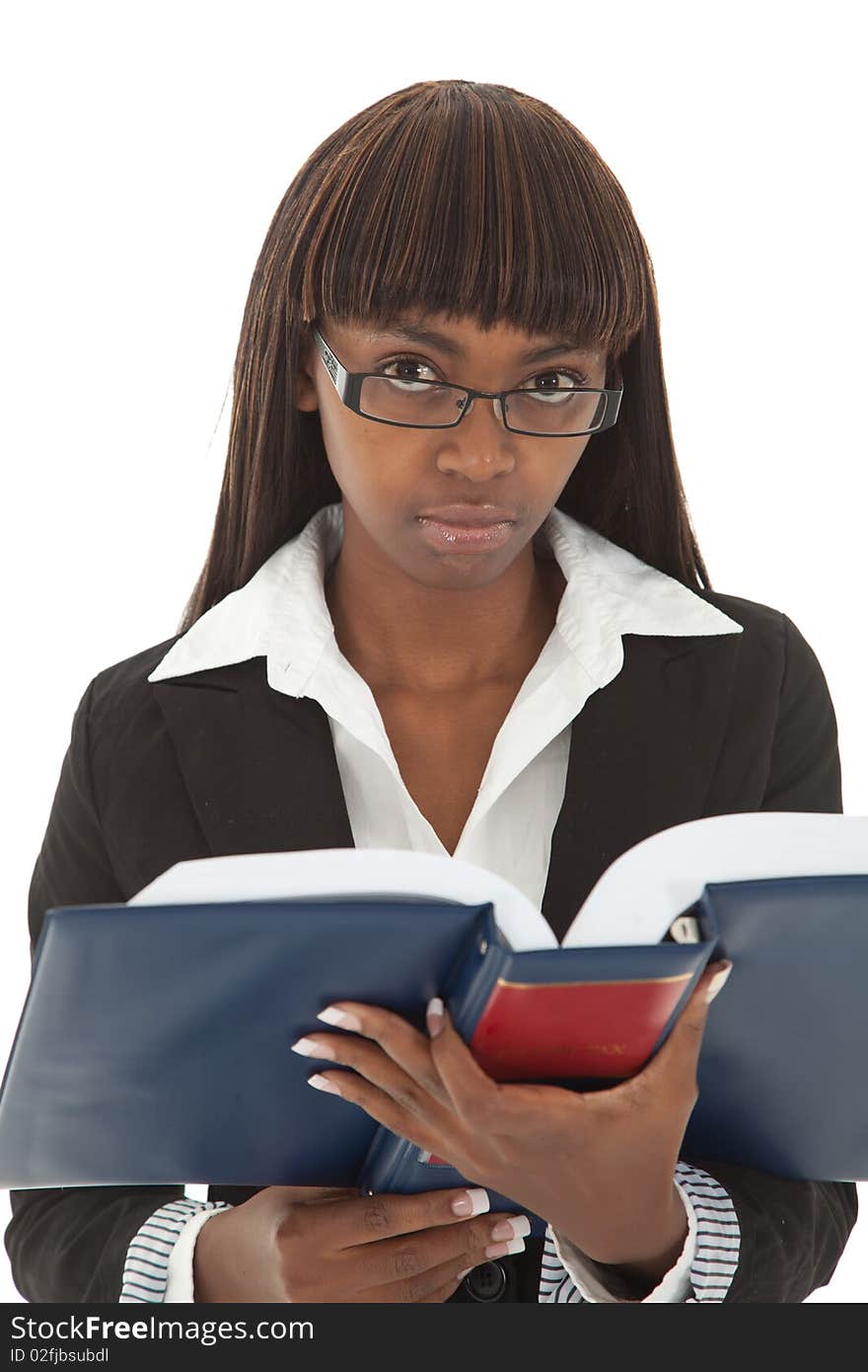 Young female professional with spectacles reading from handbook. Young female professional with spectacles reading from handbook