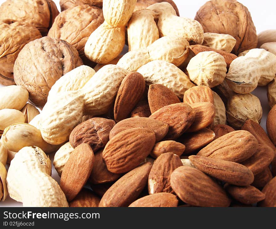 Peanuts, almonds, pistachios, walnuts on white background