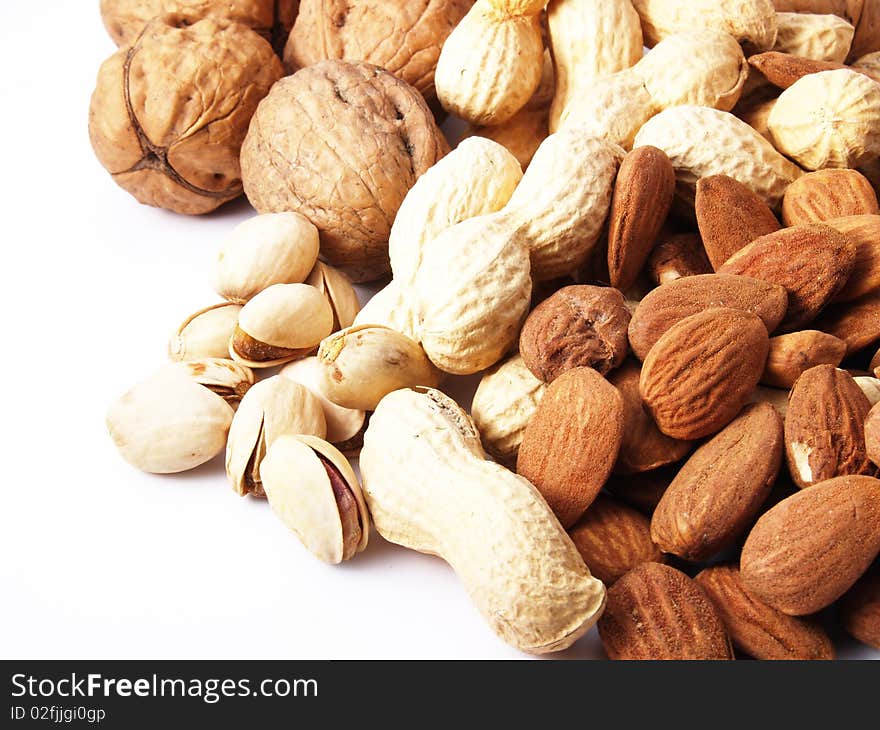 Peanuts, almonds, pistachios, walnuts on white background