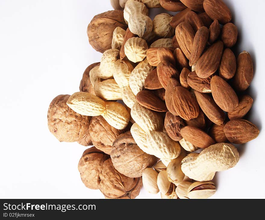 Peanuts, almonds, pistachios, walnuts on white background