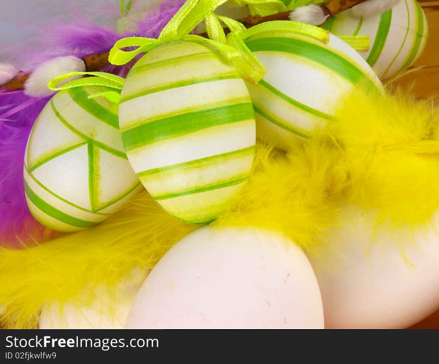 Easter decoration. Close up. Feathers in the background