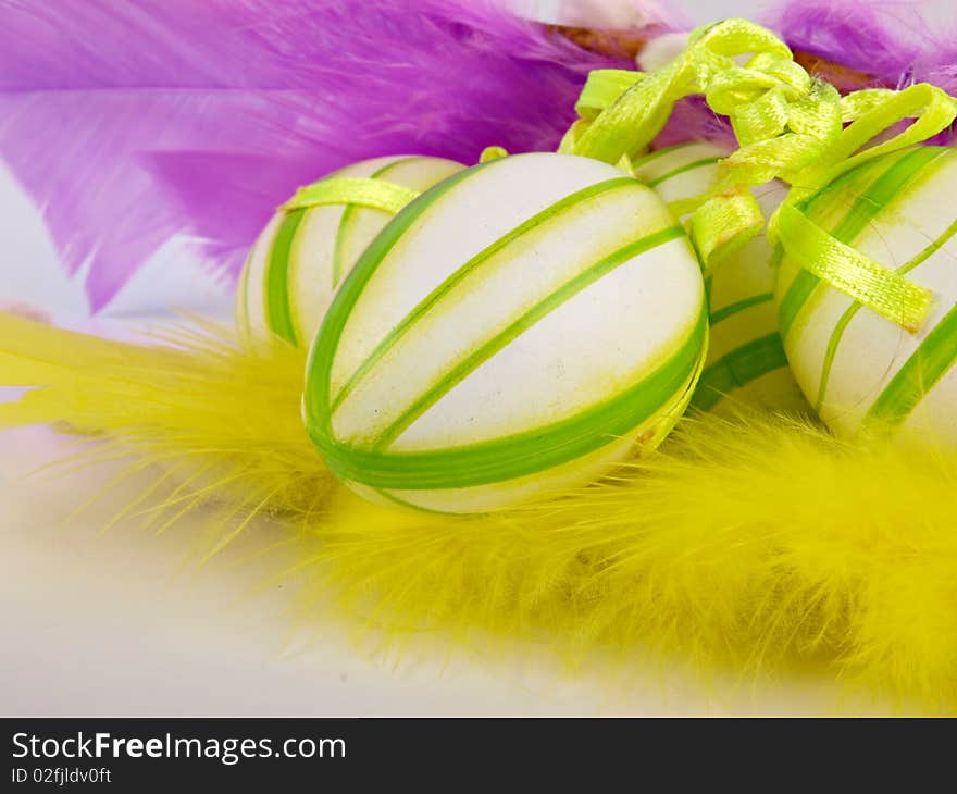 Easter decoration. Close up. Feathers in the background