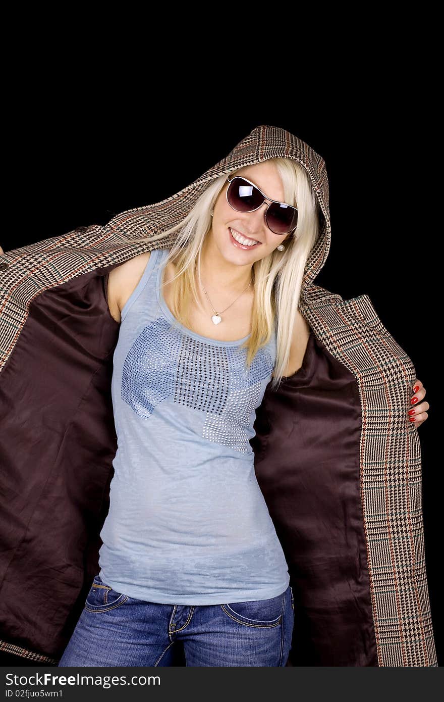 Beautiful blond girl with fashionable coat and sun glasses. Beautiful blond girl with fashionable coat and sun glasses