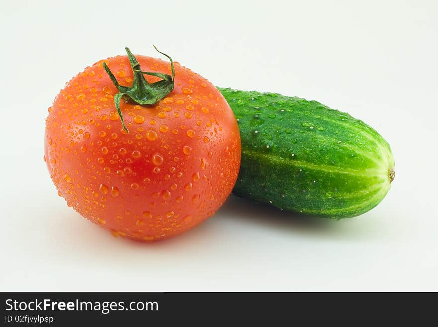 Fresh cucumber and tomato on a white background