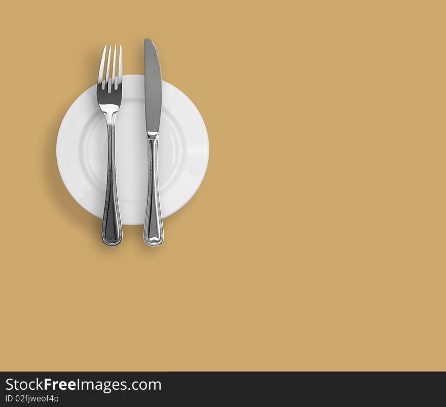 Knife, plate and fork on beige background. Knife, plate and fork on beige background