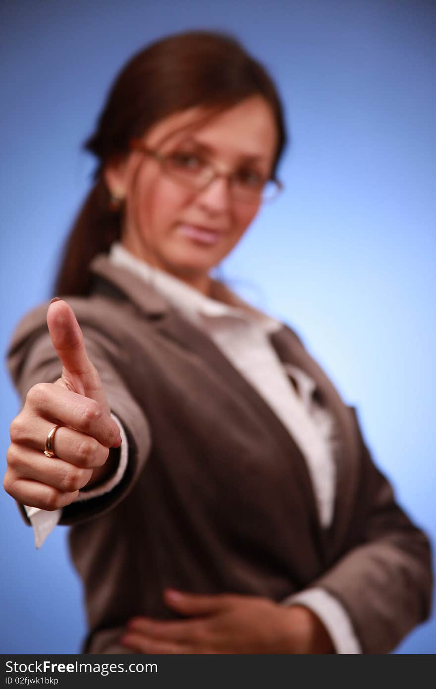 Young businesswoman showing thumb up. Young businesswoman showing thumb up