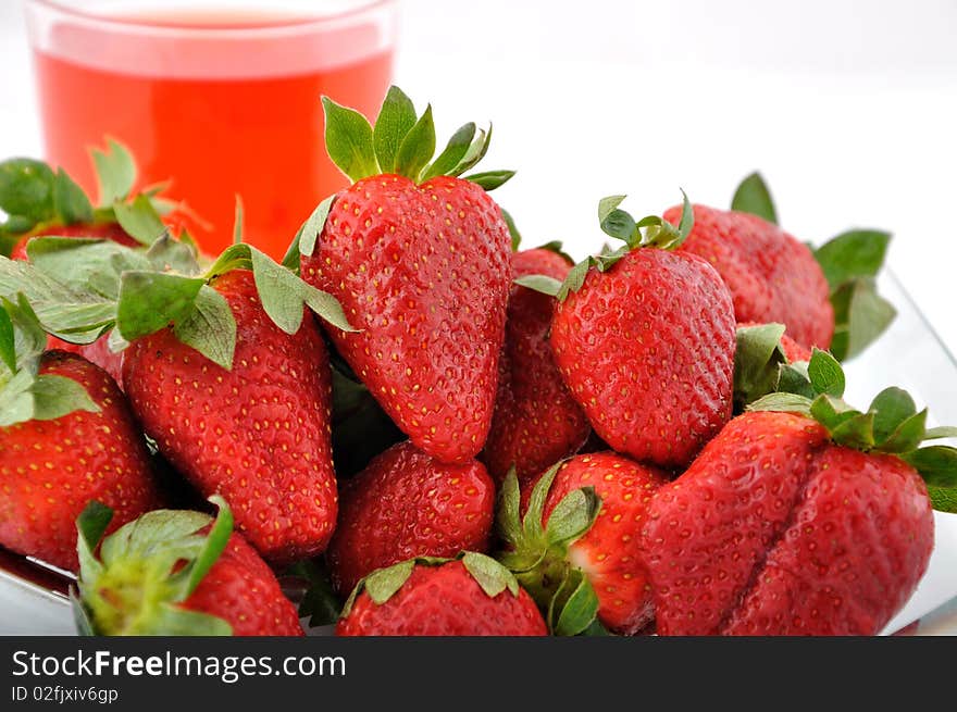 Strawberries and red glass of water. Strawberries and red glass of water