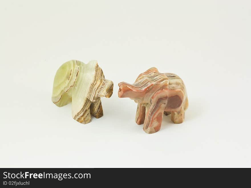 Two figures of elephants from onyx on a white background. Two figures of elephants from onyx on a white background