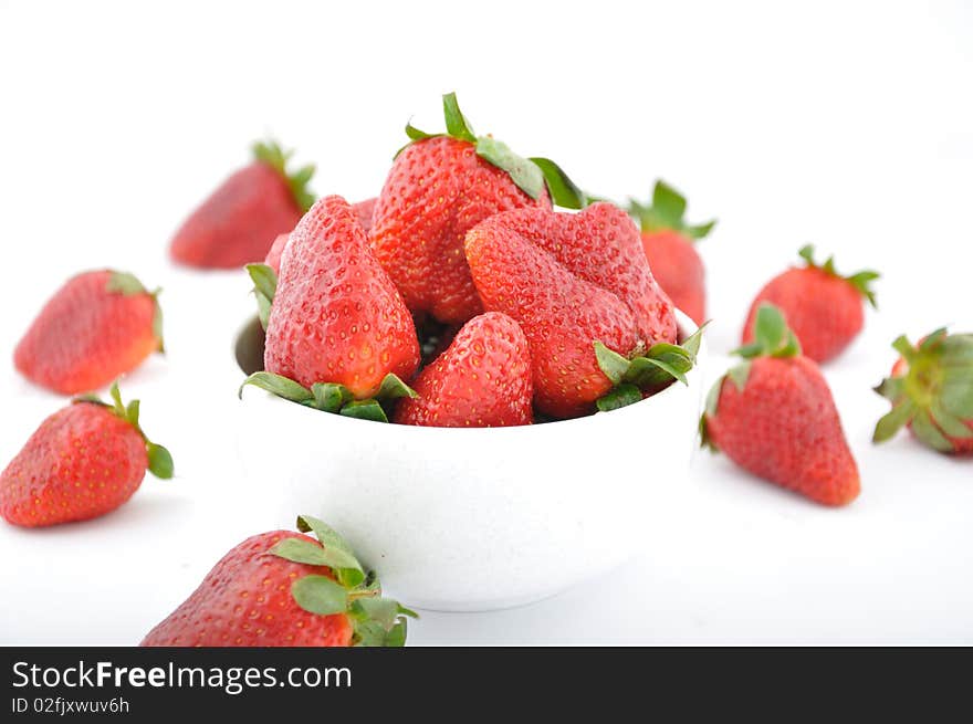 Red strawberries in bowl on table