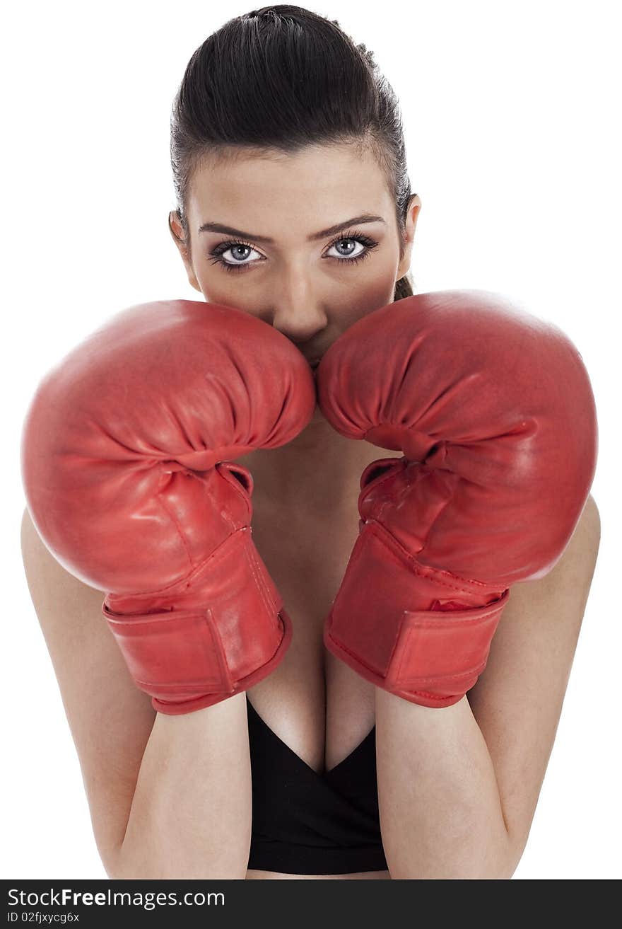 Woman covering her mouth with red gloves over white background