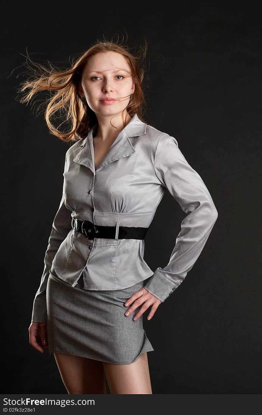 Young redhead girl posing in studio