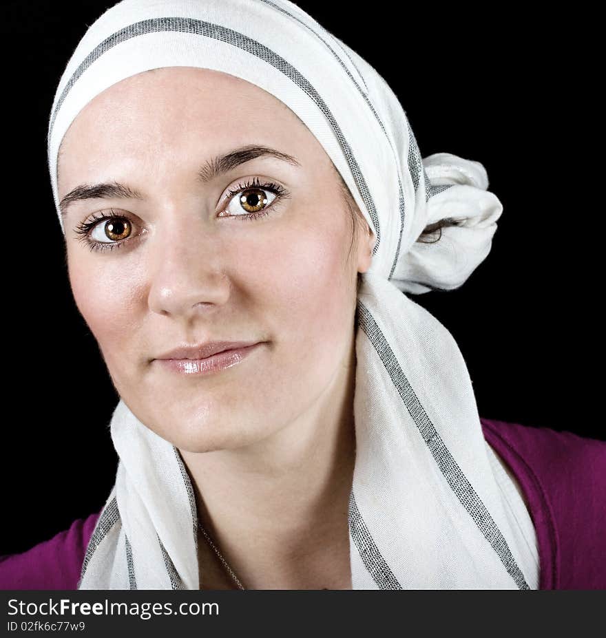 Portrait of a beautiful smiling fashionable stylish woman with a scarf on black background. Portrait of a beautiful smiling fashionable stylish woman with a scarf on black background