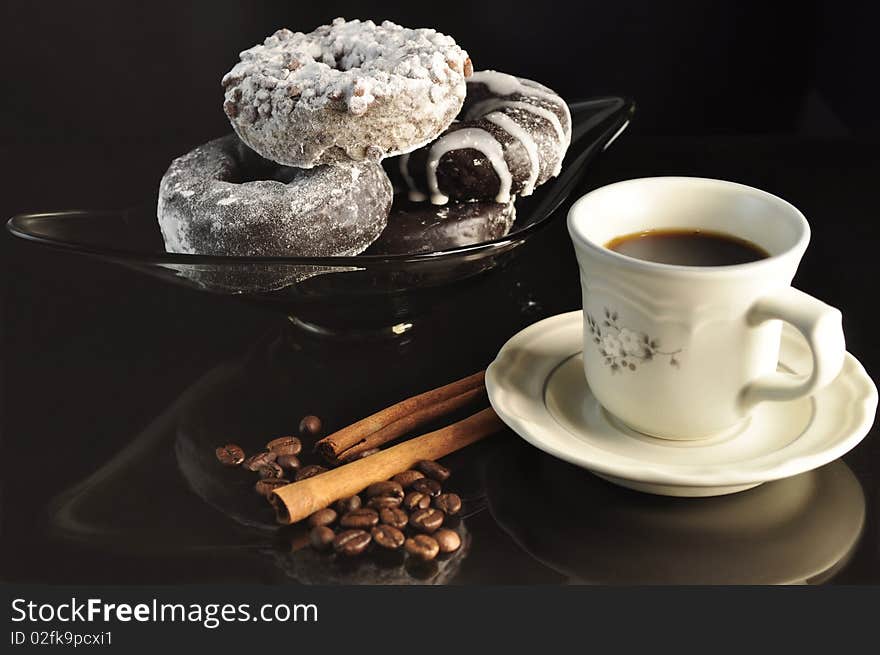 Cap of coffee with donuts on black background. Cap of coffee with donuts on black background