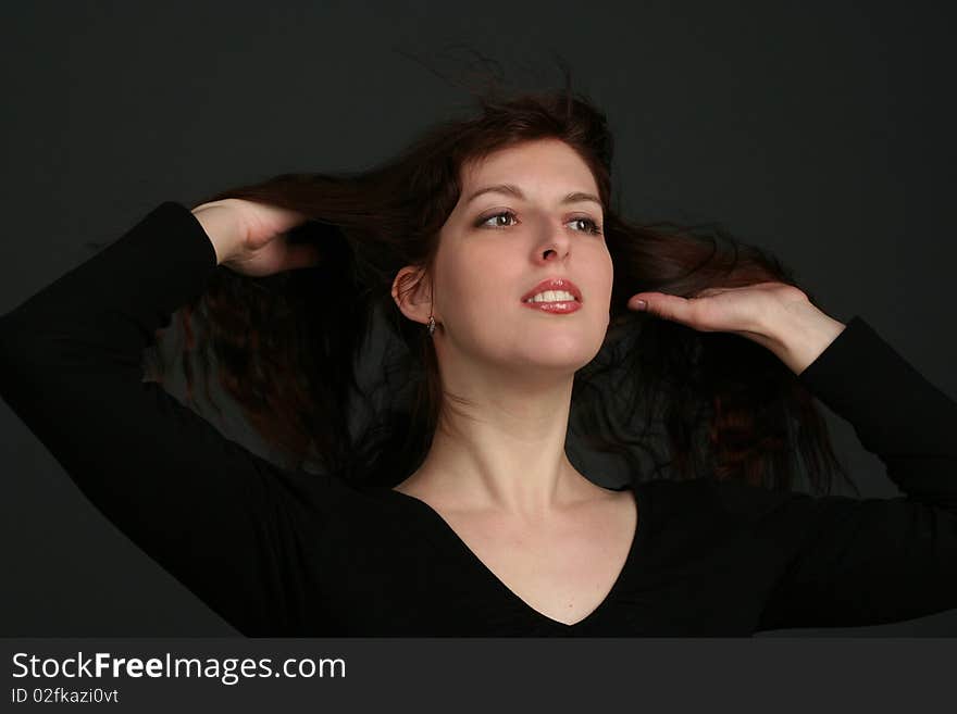 Portrait of young brunette woman isolated on black background