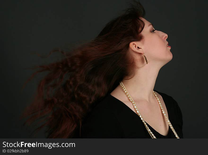 Portrait of young brunette woman isolated on black background