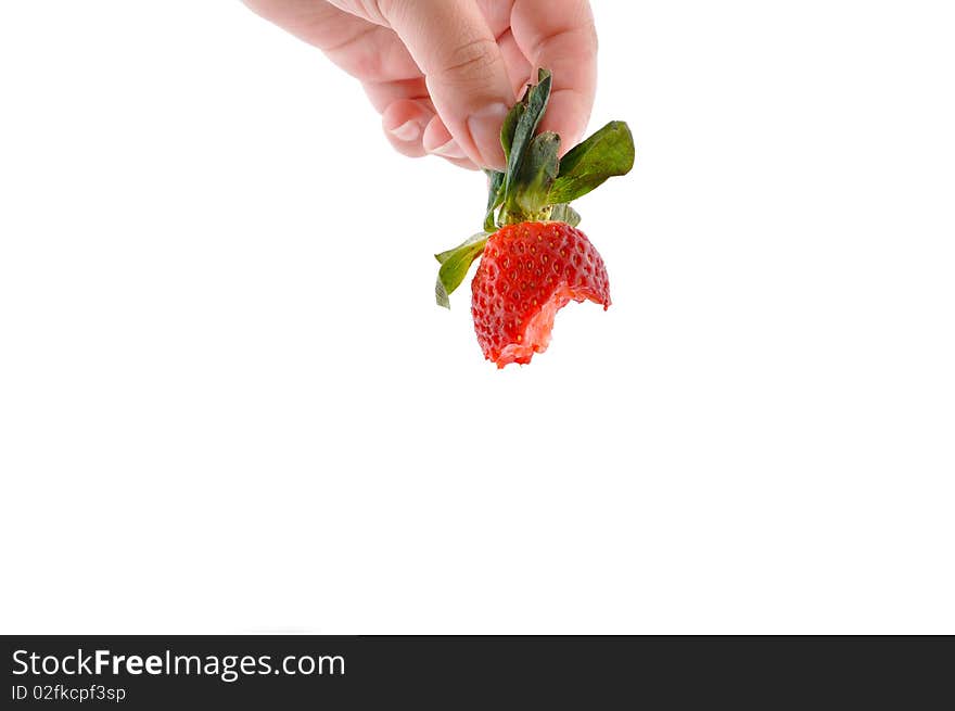 Hand is holding bite strawberry on white isolated. Hand is holding bite strawberry on white isolated