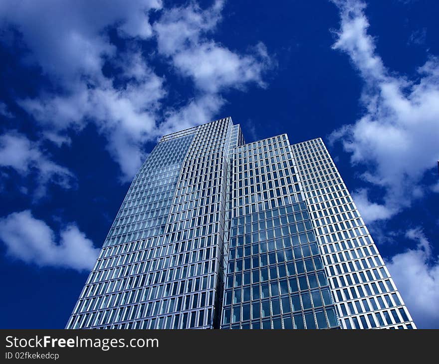 Modern office building with cloudy sky in the background