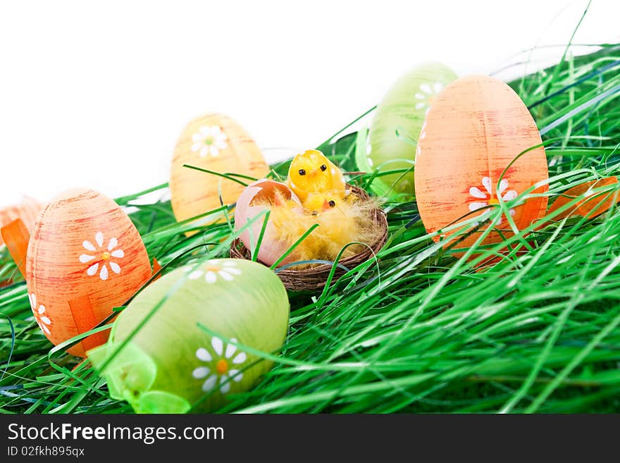 Colorful easter eggs in grass and chicken in nest. Colorful easter eggs in grass and chicken in nest