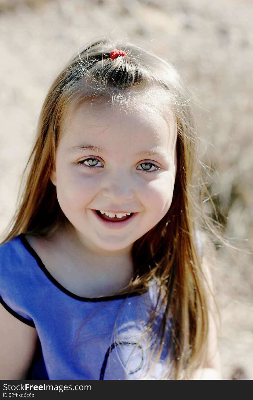 Happy, smiling girl portrait in the summertime with a desert background.  NOTE: The unusual, ghostly color of the face is because of the watermark. Happy, smiling girl portrait in the summertime with a desert background.  NOTE: The unusual, ghostly color of the face is because of the watermark.