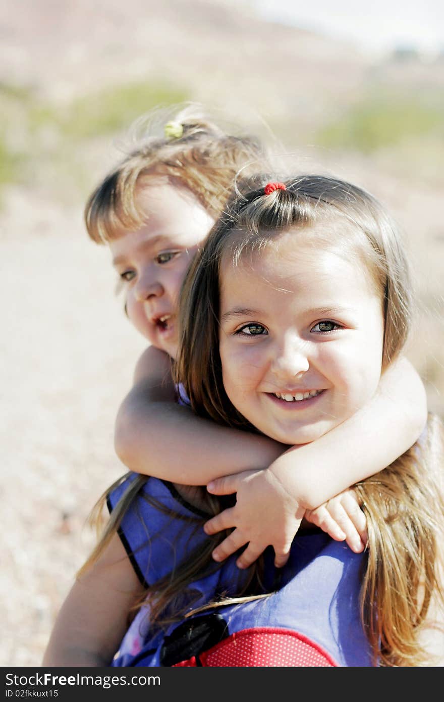 Two cute children smiling while playing and doing piggyback rides. Two cute children smiling while playing and doing piggyback rides.