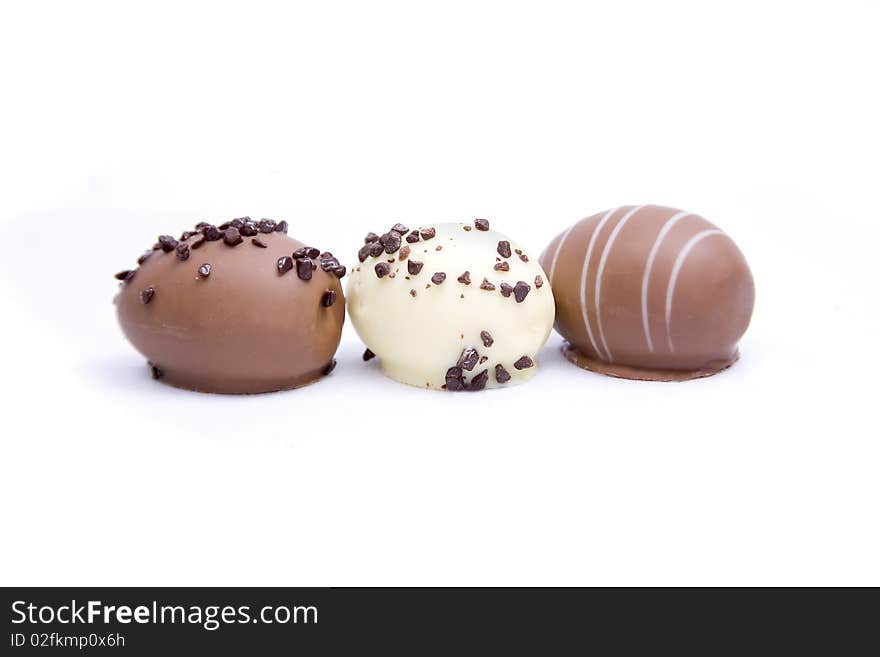 Three chocolate truffle eggs isolated on a white background