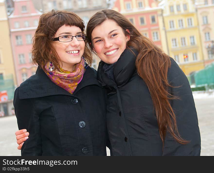 Two young beautiful girls in a city