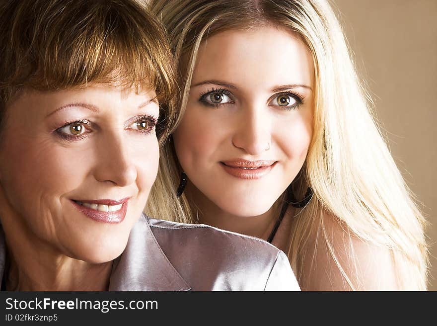 Beautiful blond daughter with her brunette mother. Beautiful blond daughter with her brunette mother