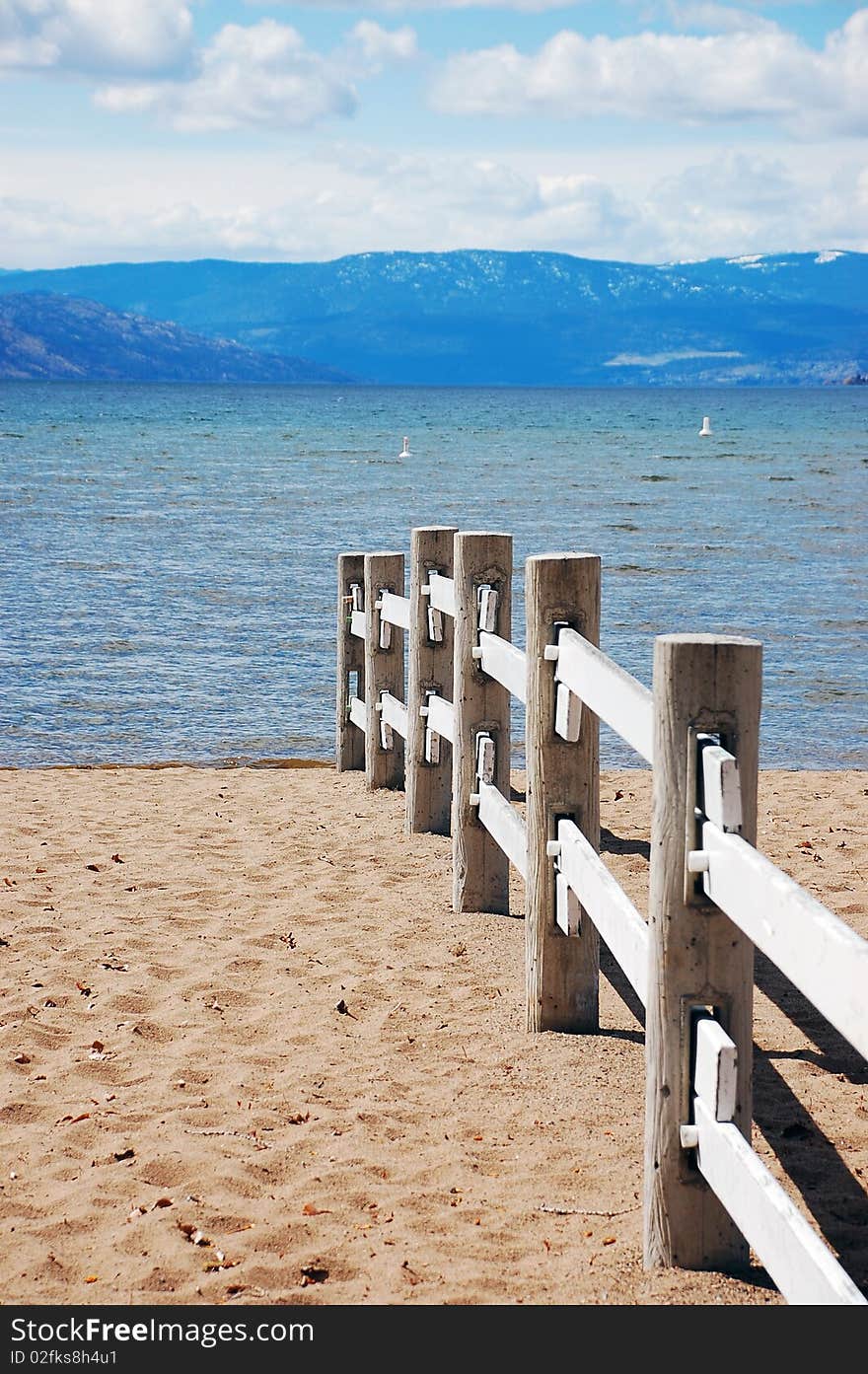 Sandy beach with wooden fence