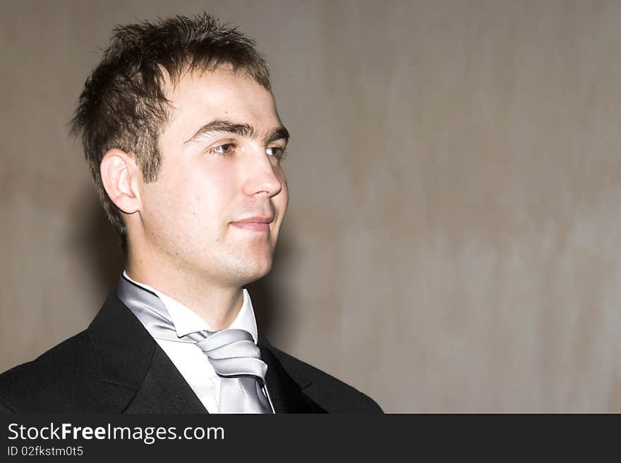 Groom, waiting for his bride in the chapel, looking proud