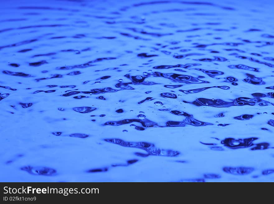 Background with blue water. Creative splashing